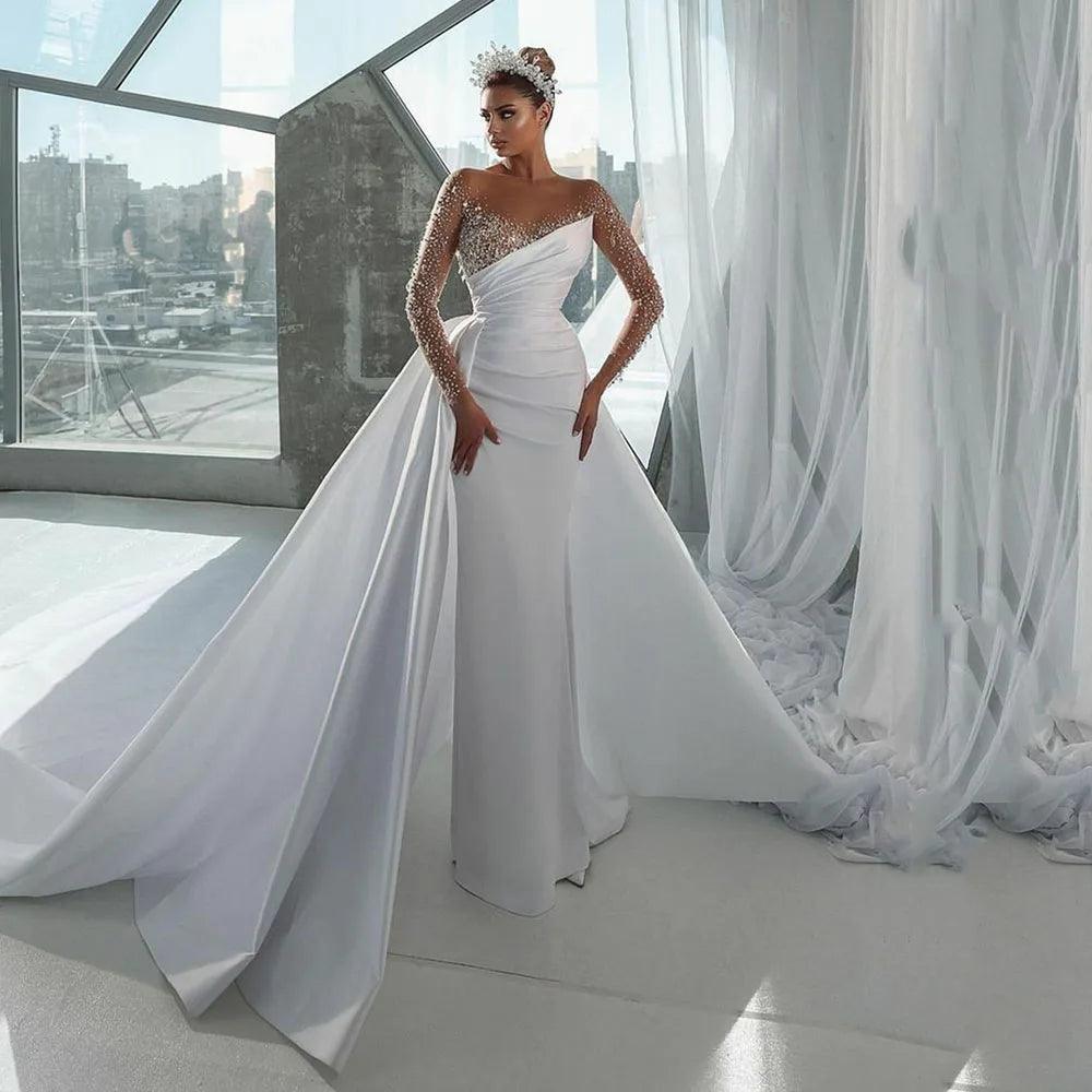 Plus Size Women Wear Elegant Mermaid Wedding Dress with Illusion Neckline, Beaded Long Sleeves, and a Detachable Overskirt